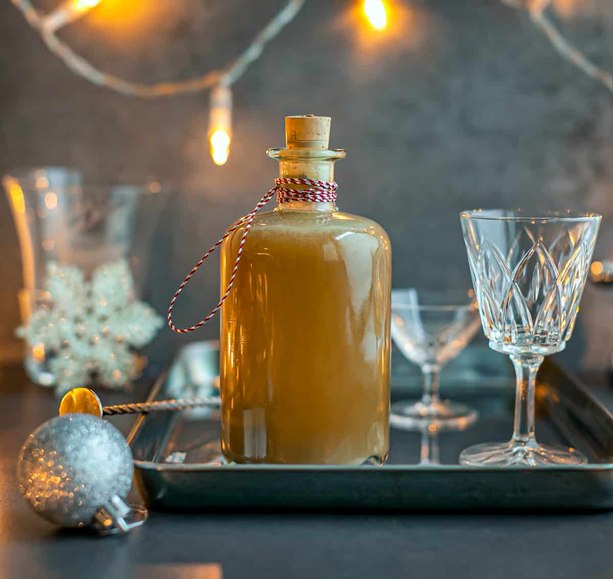 a bottle of Salted Caramel Whisky on a silver serving tray with crystal glasses